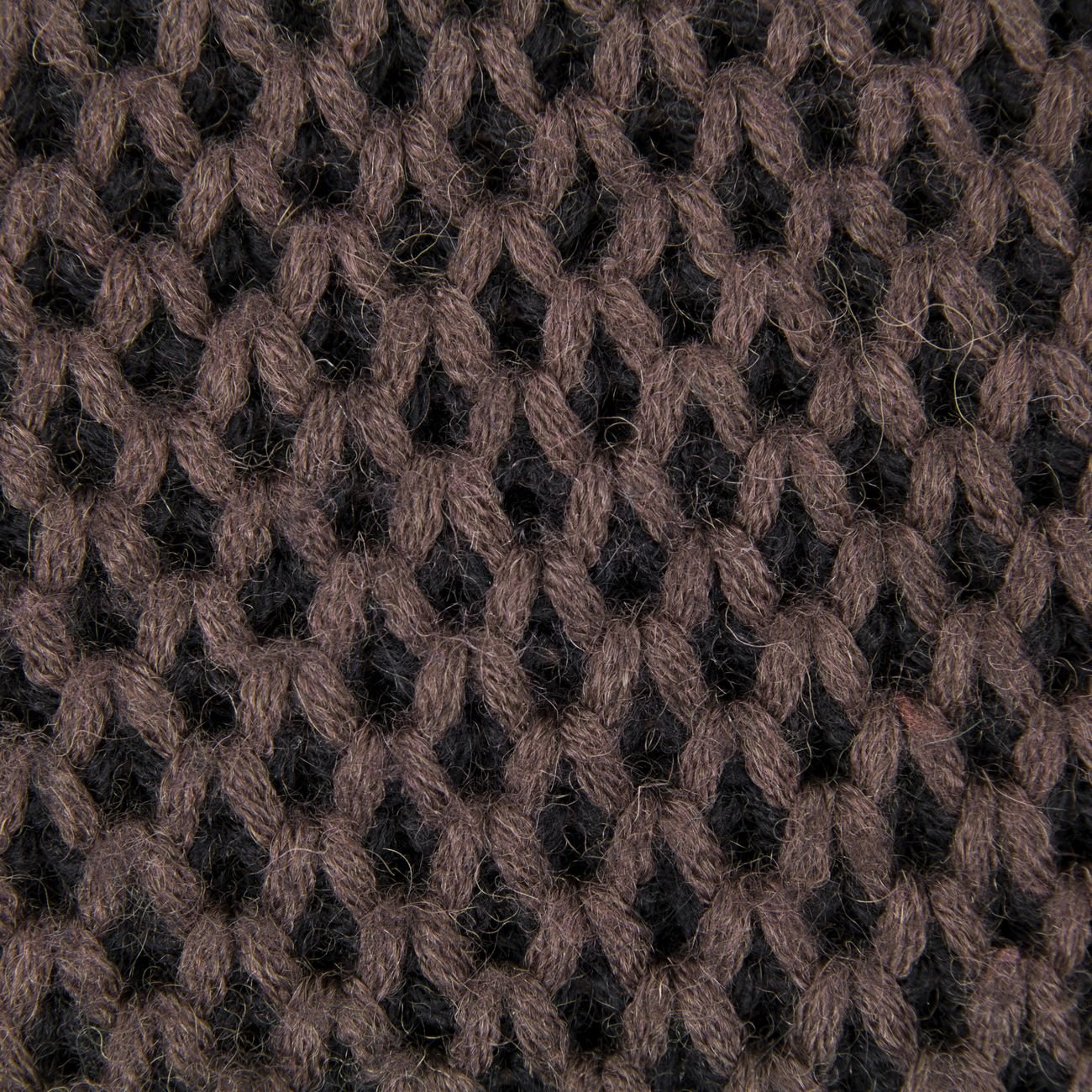 Close-up of warm knit fabric texture, the material quality that defines a considered garment