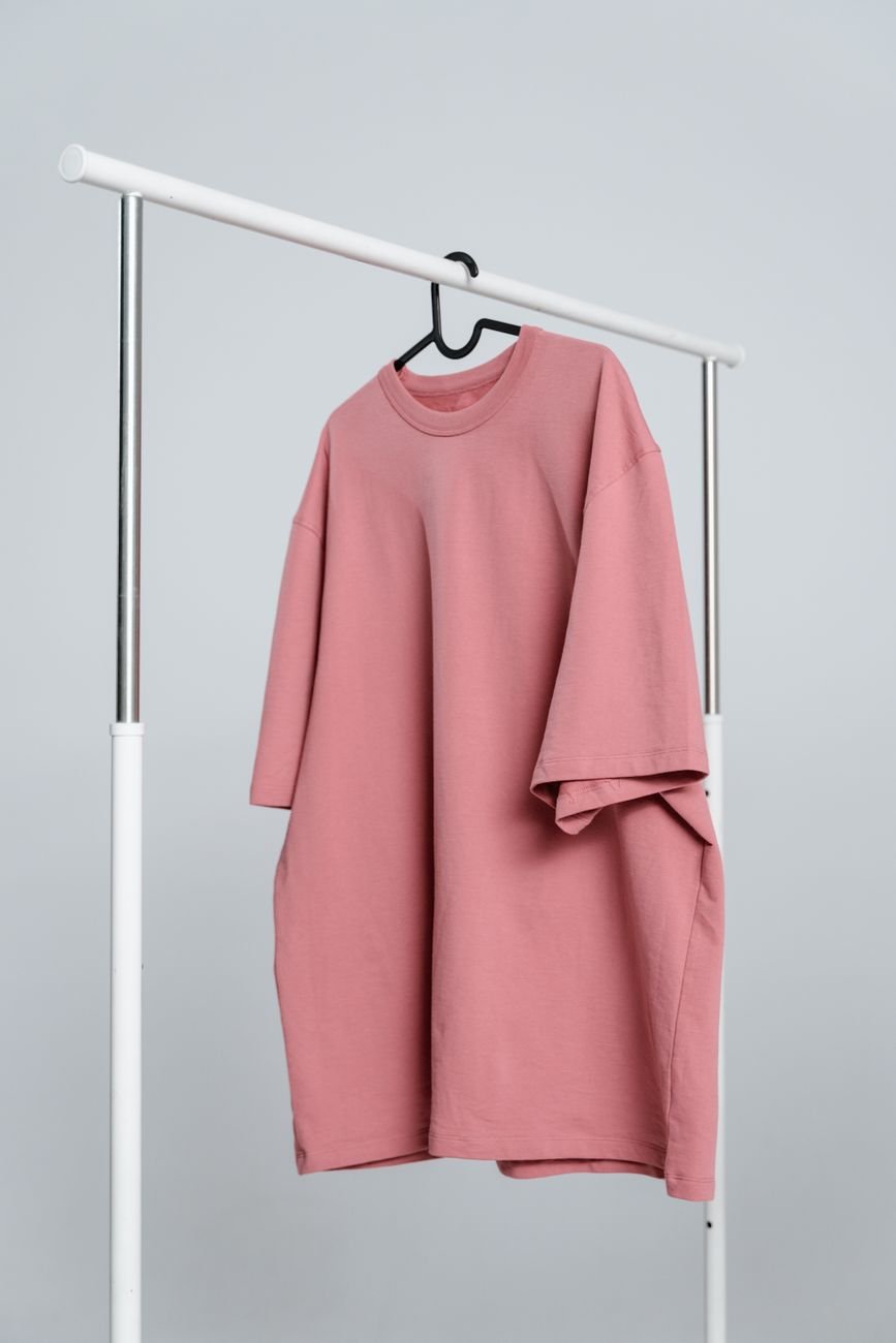 A minimal t-shirt hanging on a white rack, the kind of restrained garment that carries a considered print well